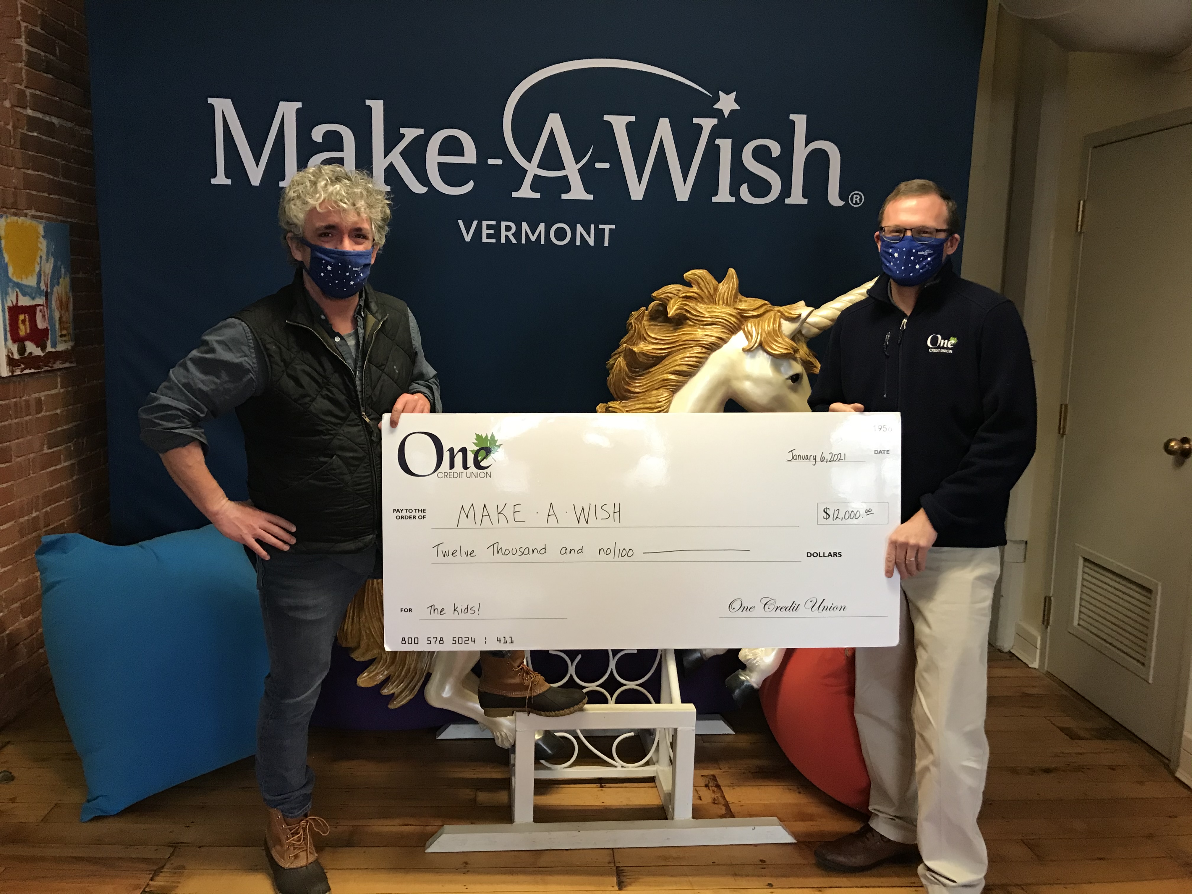 Jamie, Make-A-Wish President and CEO, and Kevin, One CU Retail Manager, with check donation.